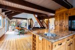 View from kitchen into dining area and vaulted living room beyond